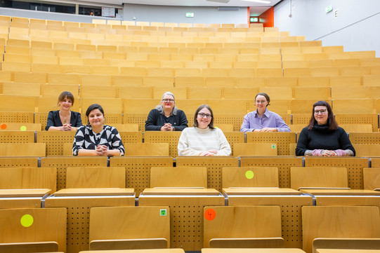 Photo: The members of the chair sit in the lecture theatre.