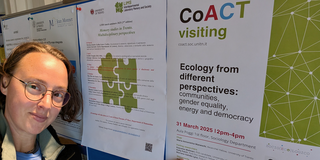 Dr. Patch points to her name on the colloquium flyer